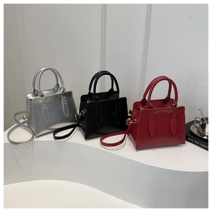 Detailed view of fashionable leather handbags in silver, black and red colors