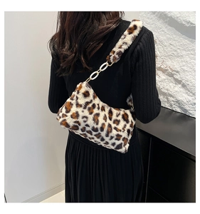 Detail of leopard print faux fur shoulder bag with decorative white chunky chain link strap