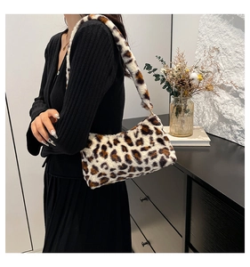 Detailed view of plush leopard print shoulder bag with soft faux fur texture on a model