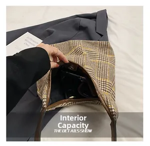 Detail view of large brown plaid tote bag showing interior capacity and magnetic closure
