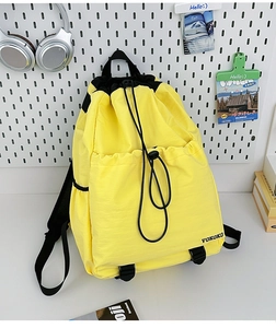 Detail of yellow waterproof nylon drawstring backpack with VOKOKO logo and side mesh pocket