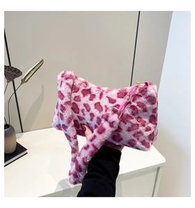 Close-up of pink leopard print plush handbag featuring an acrylic chain detail