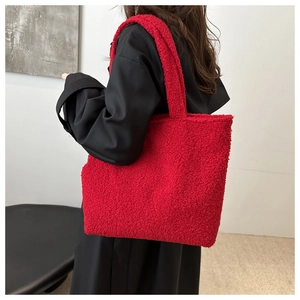 Close-up of red teddy fleece fabric texture on a large capacity shoulder tote bag