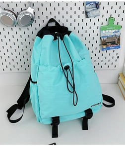 Detail of light blue drawstring backpack with VOKOKO logo and adjustable straps