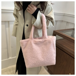 Detailed view of pink plush tote bag with soft faux shearling texture for women