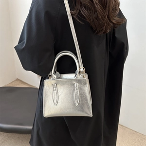 Chic metallic silver top-handle bag with pleated leather and adjustable strap for women
