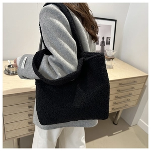 Detailed texture of black plush fleece tote bag styled with casual autumn office wear