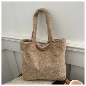 Close-up of the plush teddy fleece texture and large capacity design of the camel tote bag
