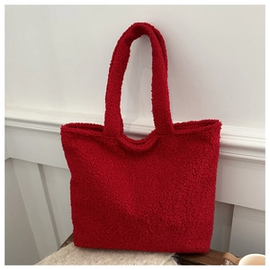 Detail of red plush faux fur tote bag with soft texture and spacious interior compartment