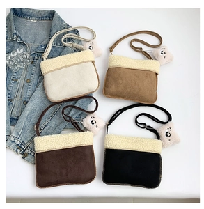 Detail of four colorful plush crossbody bags with lamb wool trim and cute bear charms