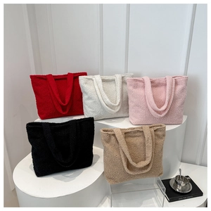 Macro view of plush textured tote bags in five different colors on white pedestals