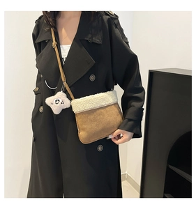 Detail showing plush brown suede texture and white faux shearling trim with a star charm