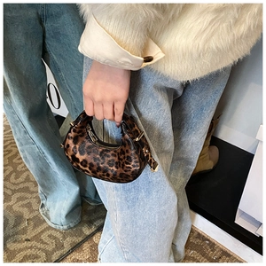 Close-up of stylish leopard print crescent bag with premium gold zipper and fuzzy texture