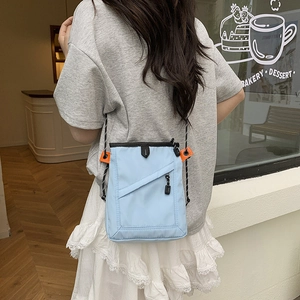 Back view of a mini light blue nylon crossbody bag with woven rope strap in a cafe setting
