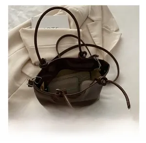 Detailed view of the large capacity dark brown tote bag with stylish knot strap design