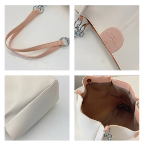 Detail of contrast tote bag with silver chain strap, brand logo, and spacious inner lining