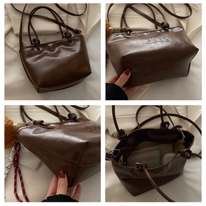 Detail view of brown vintage PU tote bag with knotted strap and inner storage space