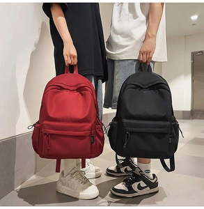 Detail view showing black and red minimalist high-capacity waterproof nylon backpacks