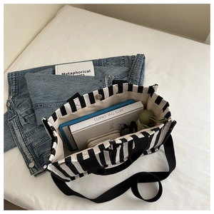 Spacious black and white striped canvas tote bag showing organized internal storage space