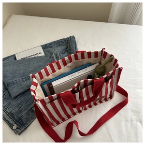 Spacious red and white striped canvas tote bag showing interior pockets and large capacity