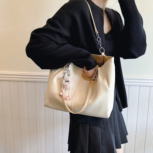 Minimalist cream tote bag with metal chain strap and cute plush charm for women