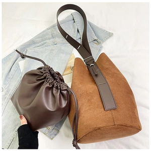 Detail view of brown matte bucket bag set with inner drawstring pouch on casual denim