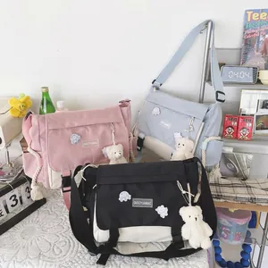 Japanese style large capacity messenger bags in pink, blue and black with bear charm