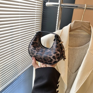 Fashionable leopard print crescent bag with knotted handle and vintage aesthetic
