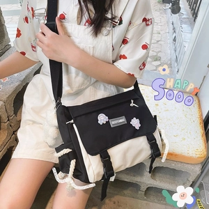 Japanese style black and white canvas messenger bag with cartoon badges for women