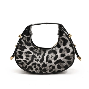 Chic crescent hobo bag with dark leopard print and gold stud accents for women