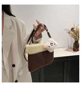 Detail of winter crossbody bag featuring brown suede fabric and beige faux fur trim