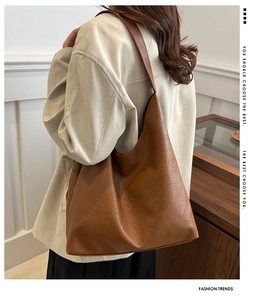 Detail view of the soft lychee texture and rich caramel finish of this tote bag