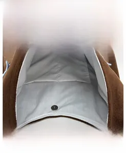 Detail view of plush tote bag interior with magnetic clasp and double pocket slots