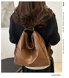 Brown vintage faux leather backpack shown on model highlighting spacious design and side pocket