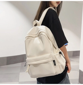 Side view of an off-white minimalist backpack featuring large capacity and side pockets