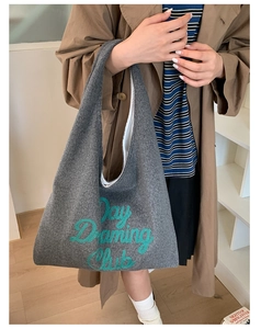 Detailed texture of charcoal felt tote bag featuring green Day Dreaming Club embroidery