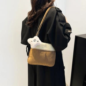 Vintage brown suede shoulder bag with white fleece trim and star charm on black coat