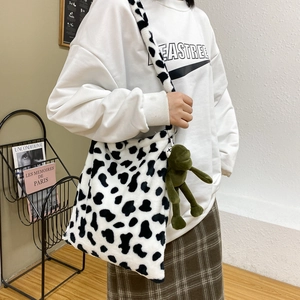 Cute faux fur cow print crossbody bag with green plush frog pendant for women