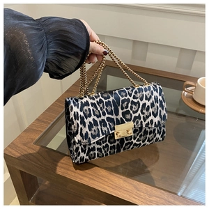 Close-up of leopard print shoulder bag with gold chain strap and metal lock detail