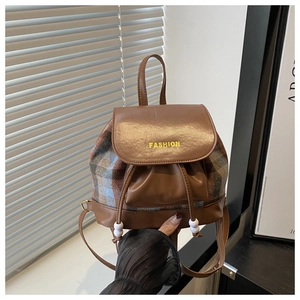 Detail of vintage plaid mini backpack with leather flap and beaded drawstring closure