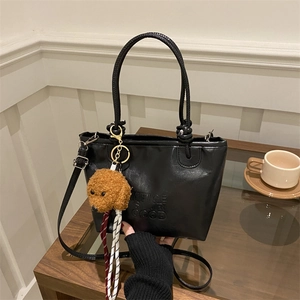 Vintage black crossbody bag with cute teddy charm and leather-like finish for women