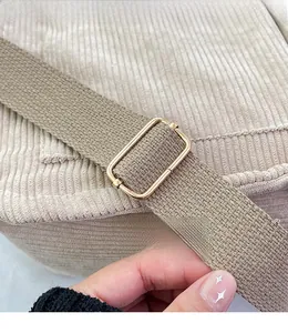 Detail view of adjustable corduroy shoulder strap with high-quality golden metal buckle