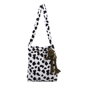 Cute faux fur shoulder bag with black and white cow print and brown frog pendant decoration
