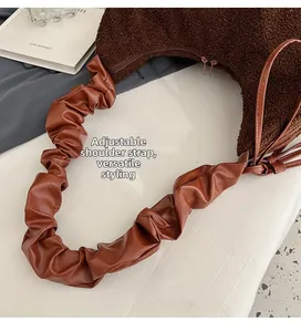 Close-up of adjustable shoulder strap and fuzzy teddy material on the half-moon bag