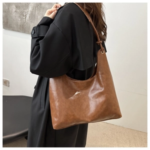 Close-up of the vintage brown faux leather hobo bag showing texture and gold hardware details