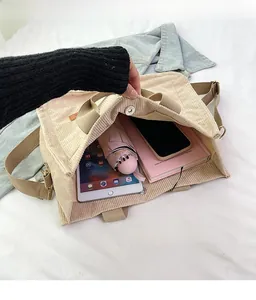 Interior view of large beige corduroy tote bag showing spacious storage for tablet and umbrella