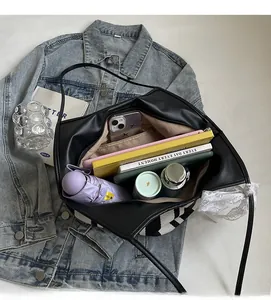 Top view of spacious black leather tote bag interior showing capacity for daily essentials