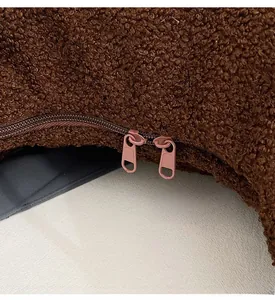 Close-up of smooth metal double zippers on brown teddy fleece shoulder bag