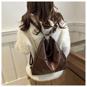 Detailed view of the dark brown retro large capacity tote backpack on a model back
