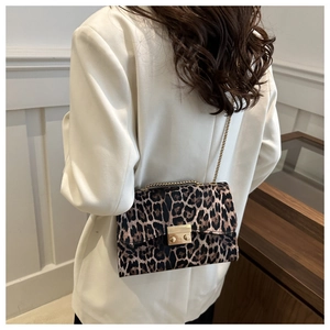 Detail of leopard print shoulder bag with gold chain strap and metal lock closure